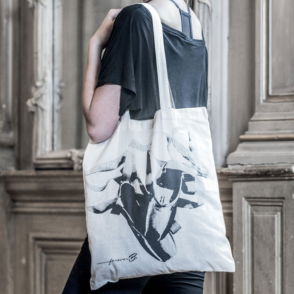 Beige tote bag, black pointe shoes